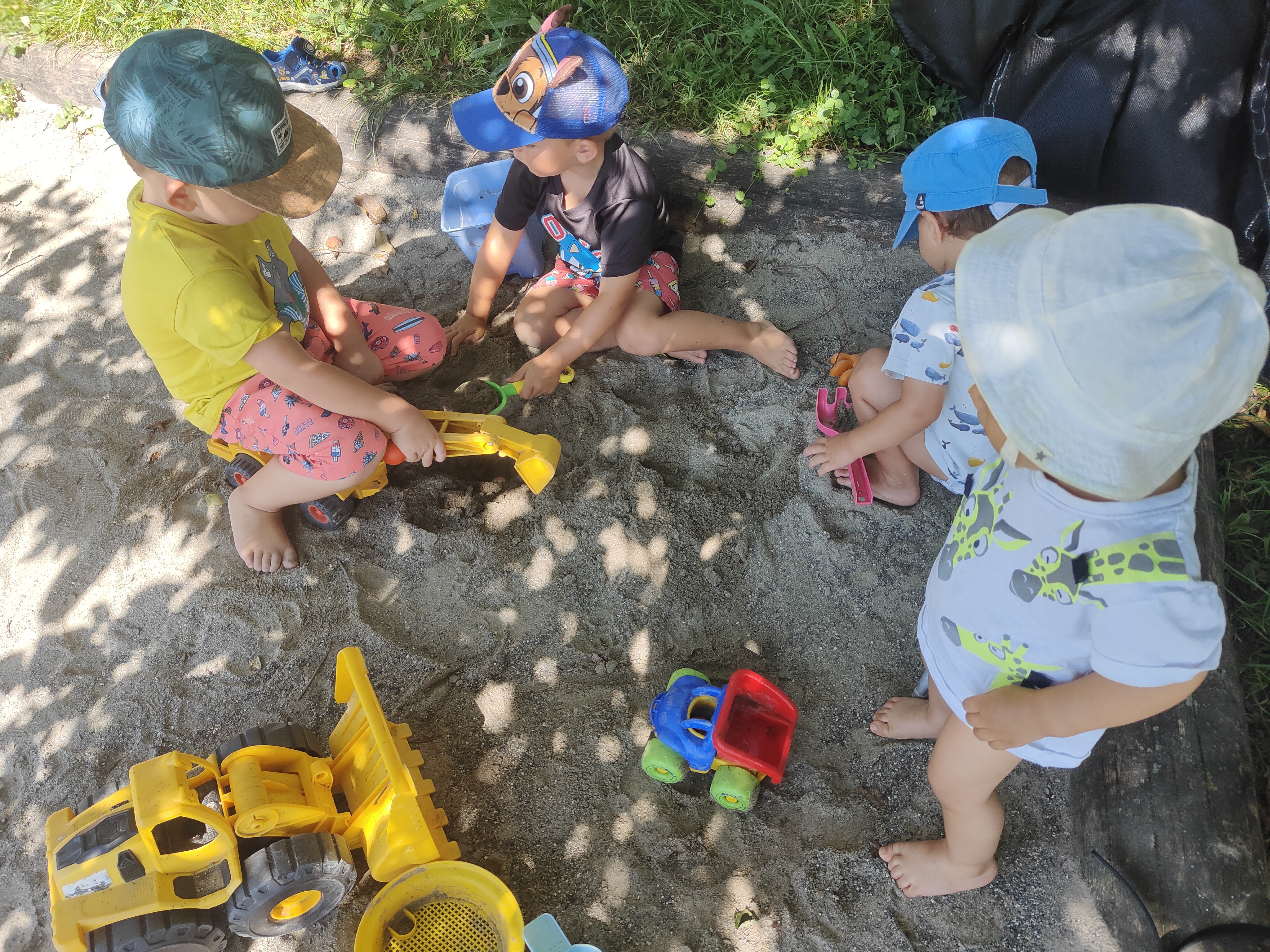 Two toddlers laughing in the garden
