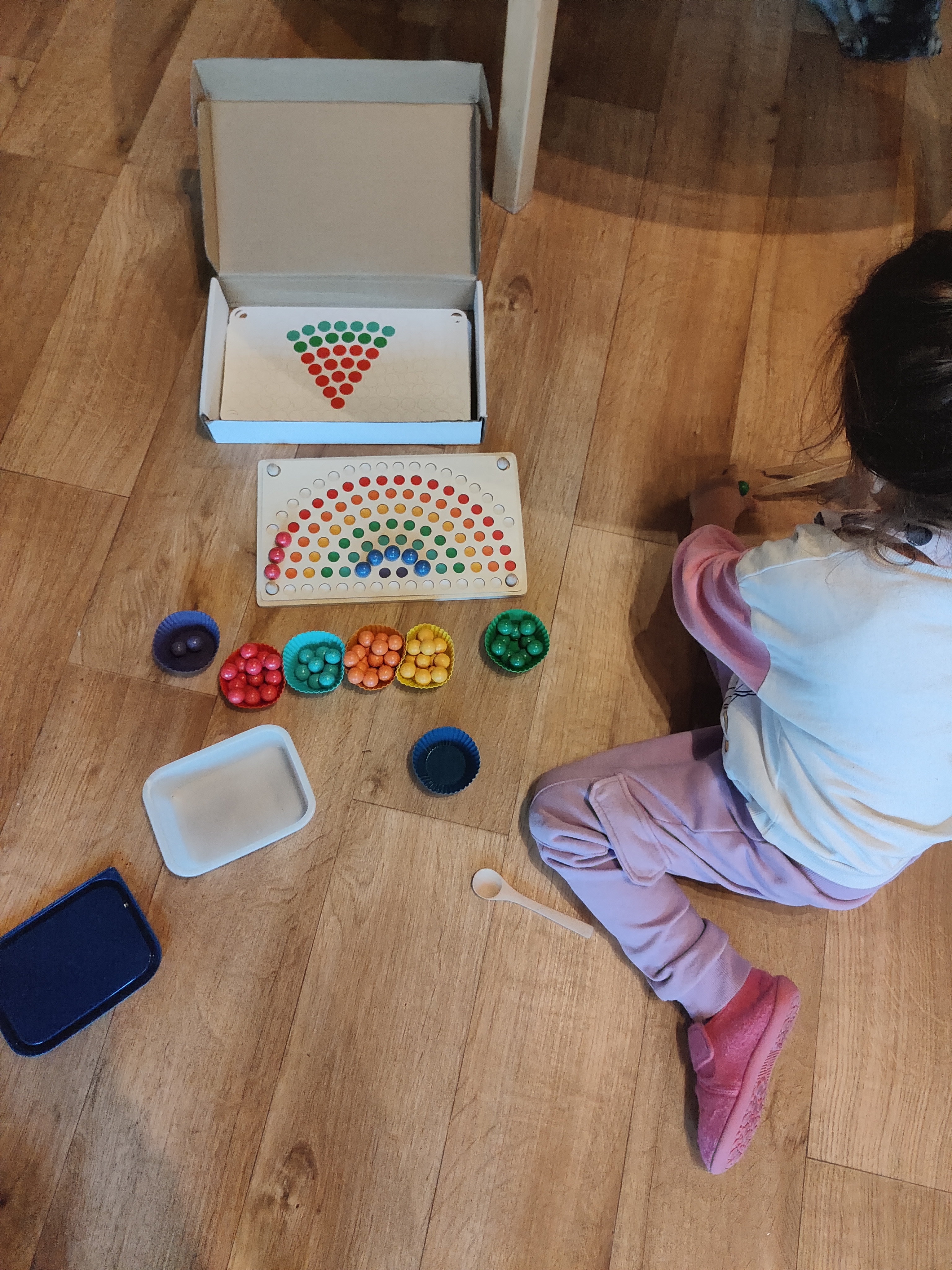 Child playing with colourful educational toys
